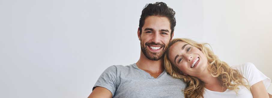 Woman and man smiling after teeth whitening