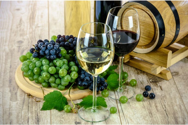 two glasses of wine, grapes and wine barrel