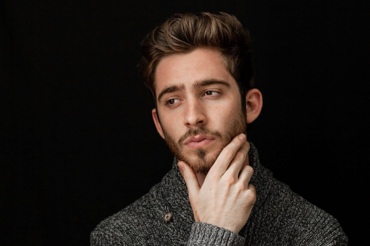 man holding his chin pondering what gingivitis is