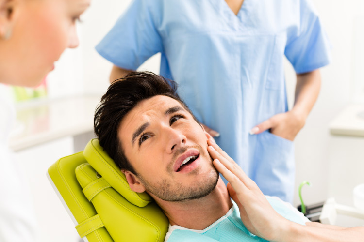 man in the dentist's chair ready for root canal therapy