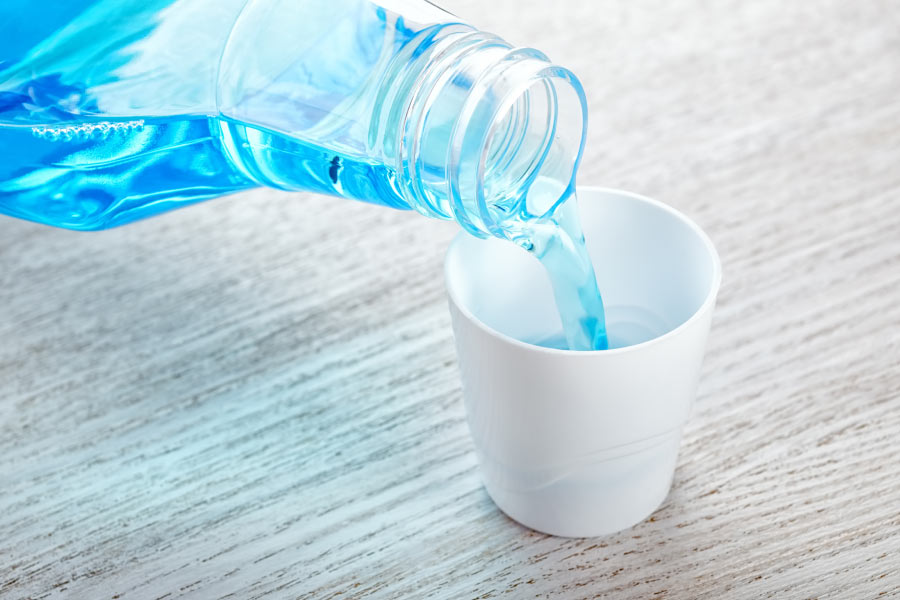 mouthwash being pored into a cup