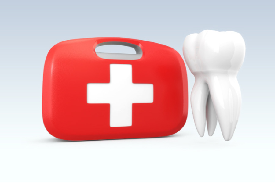 tooth next to a first aid kit for emergency dental work